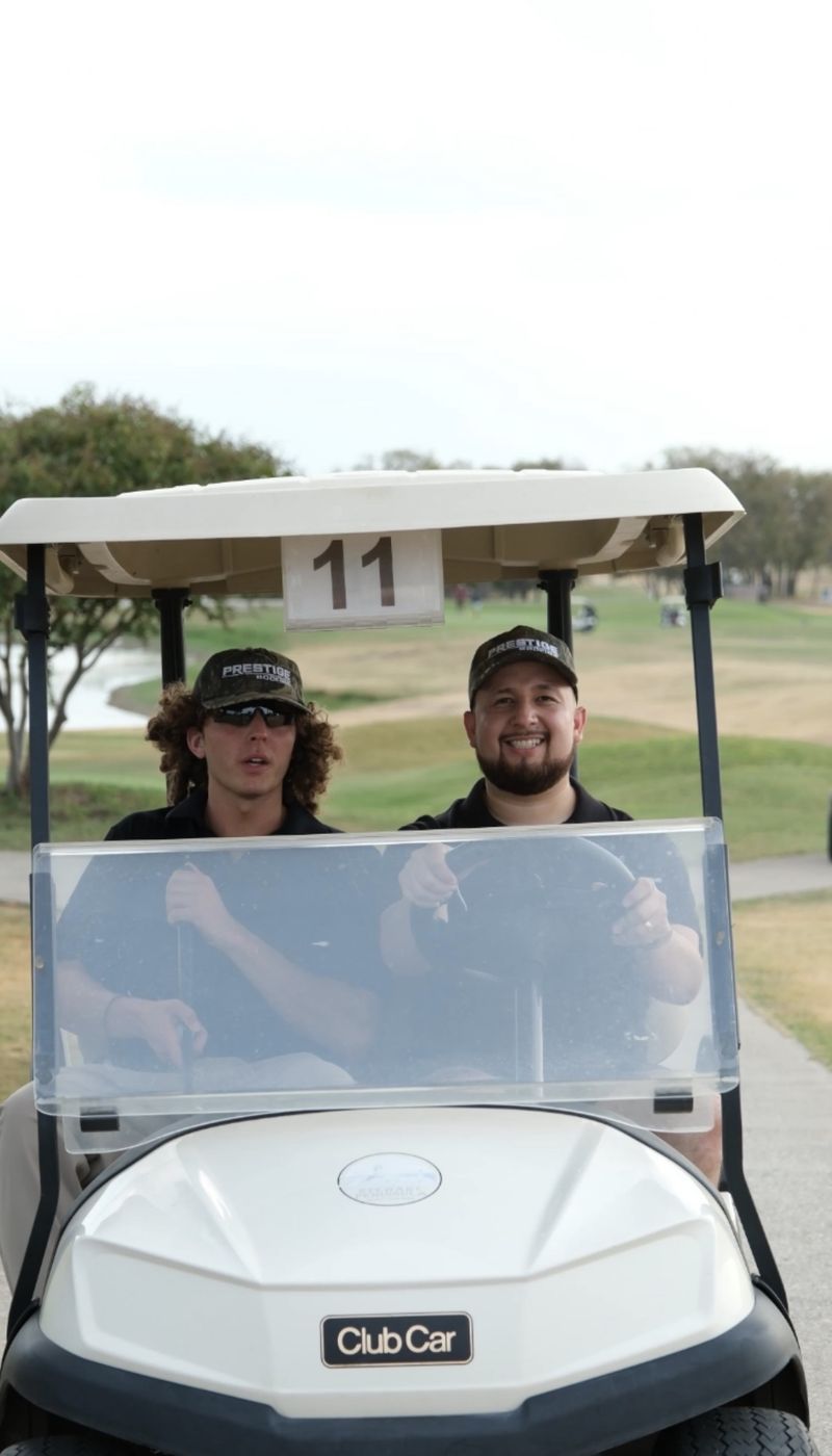 Prestige team members in a golf cart