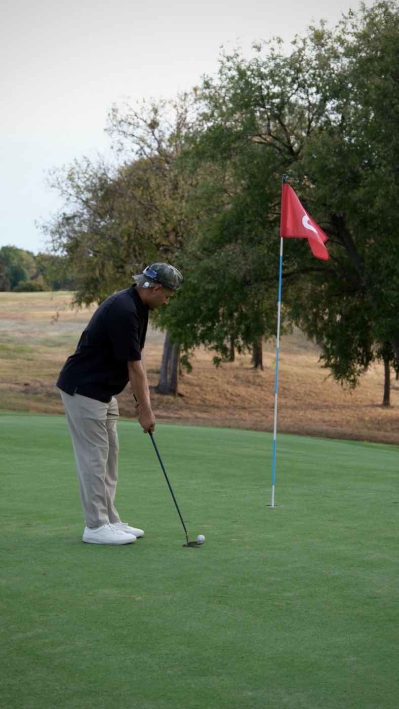 Prestige team member putting on the green